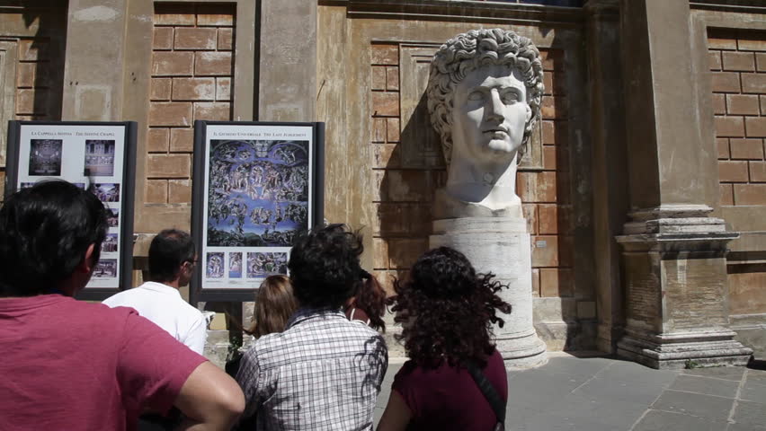 ROME - CIRCA MAY 2012: Tourists looking at Head of Augustus