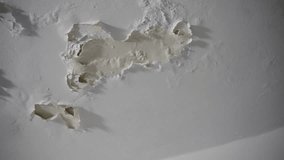 Peeling paint on house ceiling due to moisture and humidity in closed room. Old apartment or leaking floor upstairs causing wall paint to fall apart or to peel off and crack. Home issues to fix - Powered by Shutterstock - Get 15% off with code: PIKWIZARD15