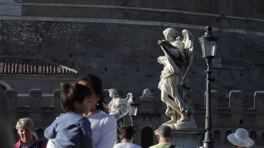 ROME - CIRCA MAY 2012:  Female tourists walk down the angel-lined Ponte