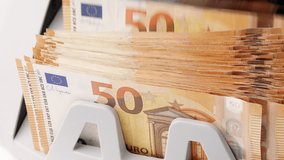Bill counter cash money. Euro banknotes. Bank automatic equipment. Close-up of 50 euro banknotes counted macro top view slow motion. European union currency. Inflation, economy, investment, income - Powered by Shutterstock - Get 15% off with code: PIKWIZARD15