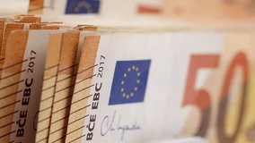 Euro banknotes. Bank automatic equipment for counting cash money. Close-up of 50 euro banknotes counted macro top view slow motion. European union currency. Inflation,  economy, investment, income - Powered by Shutterstock - Get 15% off with code: PIKWIZARD15