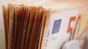 Euro banknotes. Bank automatic equipment bill counter cash money. Close-up of 50 euro banknotes counted macro top view slow motion. European union currency. Inflation,  economy, investment, income - Powered by Shutterstock - Get 15% off with code: PIKWIZARD15