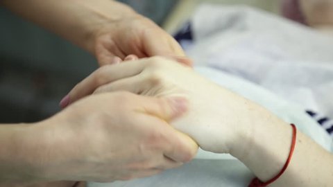 masseur makes a hand massage to client