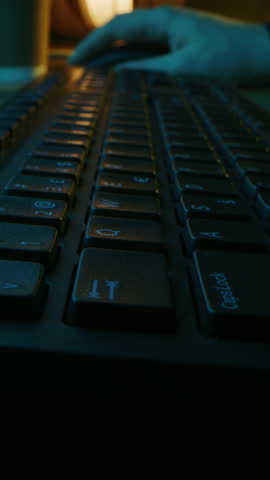 Close-up Macro Shot: Person Typing on the Computer Keyboard. Video Footage with Vertical Screen Orientation 9:16