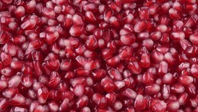 Pomegranate background 4K video. Red berry background. Pomegranate seeds top view video 4K