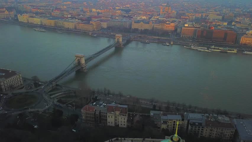 Budapest, Hungary - Aerial drone footage of Buda Castle Royal Palace with famous Szechenyi Chain Bridge at sunset