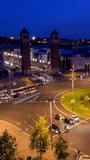 Aerial timelapse of Placa d'Espanya, Plaza de Espana, the Spanish Square in Barcelona, Catalonia, Spain with city traffic in the evening