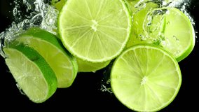 Super Slow Motion Shot of Lime Slices Falling and Flowing in Water Isolated on Black at 1000fps. - Powered by Shutterstock - Get 15% off with code: PIKWIZARD15