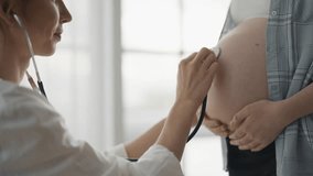 Pregnant woman consulting with a doctor. Smiling pregnant woman patient answers gynecologist questions at hospital, home, medical clinic. Doctor examine pregnant belly check up. Prenatal plan concept. - Powered by Shutterstock - Get 15% off with code: PIKWIZARD15