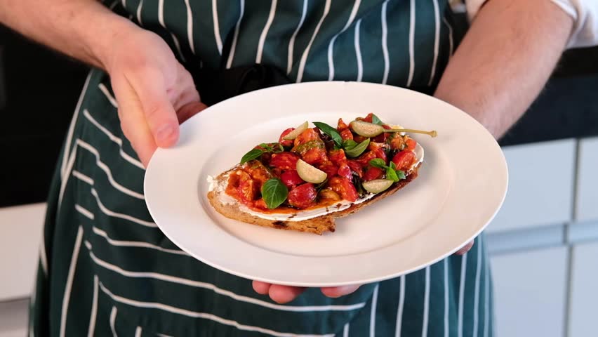 Toast with fresh cherry tomatoes and basil. Ready dish. Perfect breakfast. Slow mo