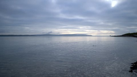 calm sea with isle of wight in background with shoreline