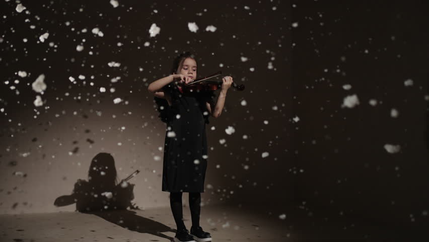 Talented Child Musician Playing Violin In Studio With Snow Flying Up, Slow Motion Reverse Shot