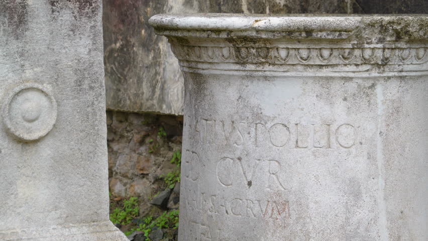 The scriptures on the big round rock on the ground in Palatino Hill in Rome Italy