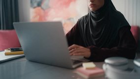 Close-up of distressed Arab woman in hijab closing laptop tired of stressful job - Powered by Shutterstock - Get 15% off with code: PIKWIZARD15