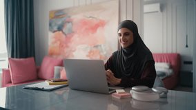 Successful Muslim business woman in hijab having remote job interview on laptop - Powered by Shutterstock - Get 15% off with code: PIKWIZARD15