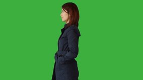 Green Screen of a Woman Standing with a Touchpad on her Hand
