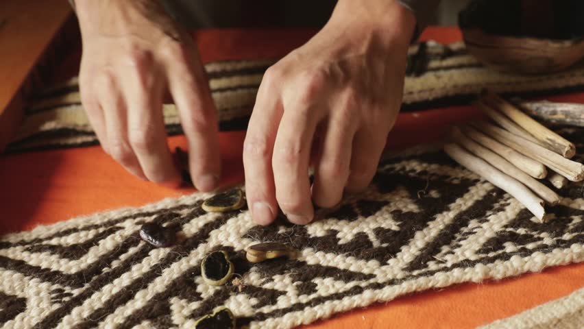 Traditional mapuche recreational games. Closeup view of a man playing Auarr-cuden mapuche game, similar to payana. He throws sliced beans. Royalty-Free Stock Footage #3462619715