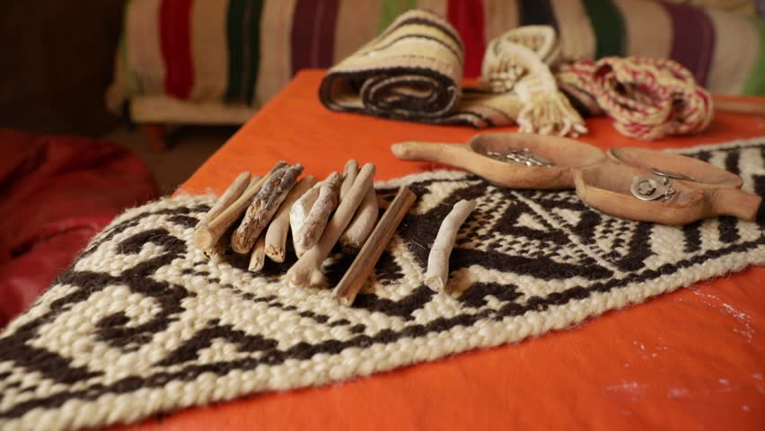 Traditional Mapuche aborigines cloths and recreational games. Closeup view of a Mapuche headband with a traditional design, and other indigenous objects Royalty-Free Stock Footage #3462622171