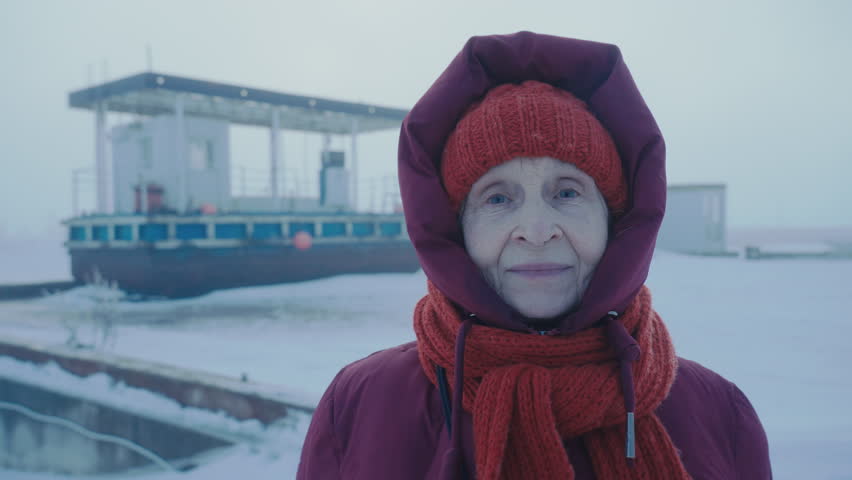 Aged female tourist traveling North Pole. Petrol station in the Arctic. Happy woman sending regards from the Antarctic circle. Oil and gas industry base worker. Extreme cold. Petroleum technician. 