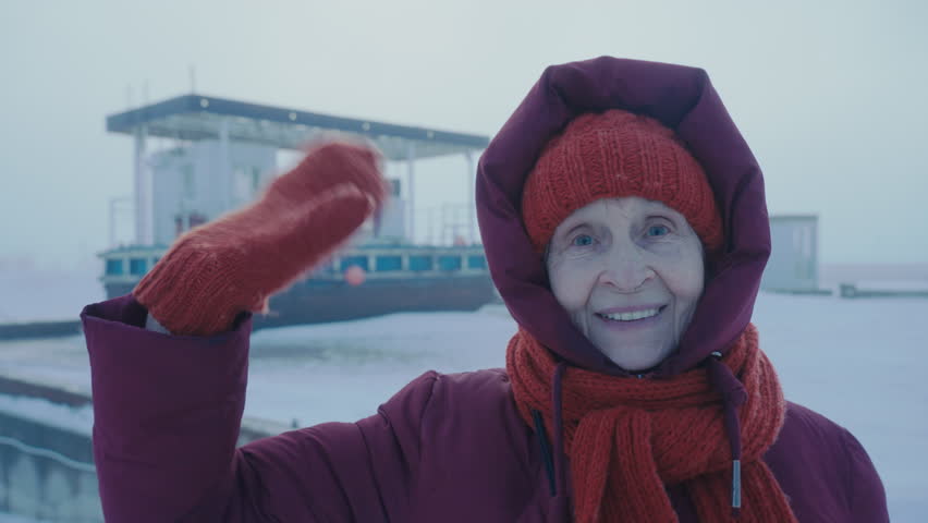 Aged female tourist traveling North Pole. Petrol station in the Arctic. Happy woman sending regards from the Antarctic circle. Oil and gas industry base worker. Extreme cold. Petroleum technician. 