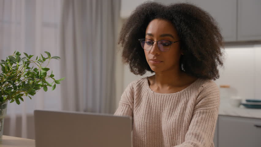 African american woman young millennial girl freelancer distant work from home quarantine female businesswoman in glasses working with laptop computer pc networking browsing online website in kitchen Royalty-Free Stock Footage #3462662131