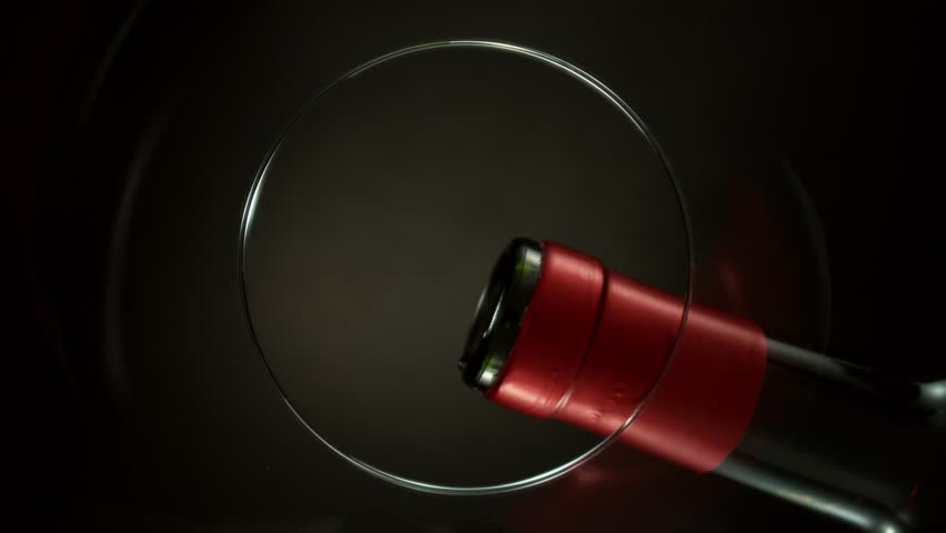 Super Slow Motion of Pouring Red Wine into Glass. Unique Perspective Composition from Bottom of the Glass. Filmed on High Speed Cinema Camera, 1000 fps.