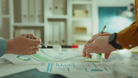 Two experienced creatives at an advertising company focus on analyzing graph data and comparing it to competitors. The goal is to develop effective strategies to overcome competition - Powered by Shutterstock - Get 15% off with code: PIKWIZARD15