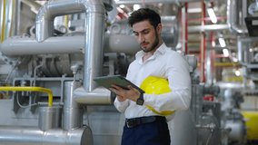 4K Professional male electrical engineer working on digital tablet at industry factory site control room. Industrial technician worker maintenance and checking power system at manufacturing plant room - Powered by Shutterstock - Get 15% off with code: PIKWIZARD15
