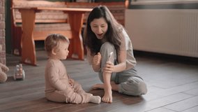 Cute little small kid child daughter having fun with adult mum enjoying using smart phone showing funny face mask app on modern gadget cellphone looking at mobile screen laughing sit on sofa at home - Powered by Shutterstock - Get 15% off with code: PIKWIZARD15