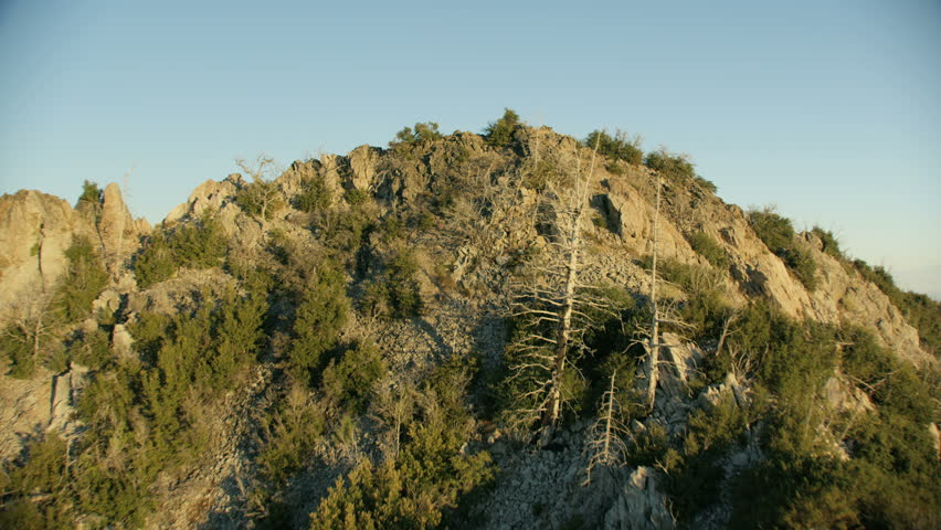Aerial sunset view sunshine over rugged rocky mountain ridge to offshore coastal fog Big Sur California USA RED WEAPON