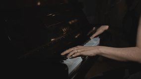 Close-up of woman playing piano. Media. Elegant woman plays piano in accelerated rhythm. Accelerated video of woman playing piano