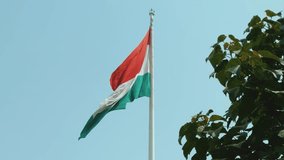 The national flag of Tajikistan on the flagpole in Dushanbe. Asia. Video with the flag of Tajikistan waving, flag on a pole, horizontal, rectangular, raising the flag. 4K