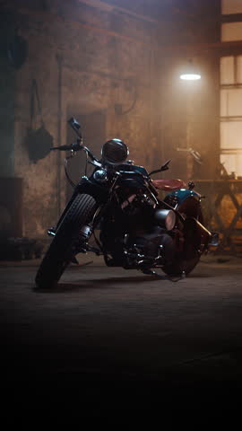 Vertical Footage of a Custom Bobber Motorbike Standing in an Authentic Creative Workshop. Vintage Style Motorcycle Under Warm Lamp Light in a Garage.