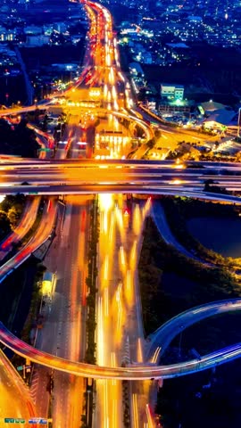 Timelapse of car traffic transportation above circle roundabout road in Asian city. Drone aerial view fly in circle, high angle. Public transport, commuter city life concept Royalty-Free Stock Footage #3462910813