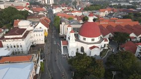 drone orbit view of a church building in an old town