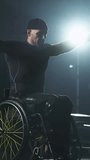 Fortitude, disabled sporty man in wheelchair lifting weights on block machine, strength training on block device, vertical video.