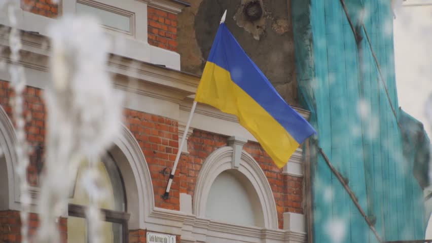 Ukrainian flag standing on the wall of the house Royalty-Free Stock Footage #3462985383