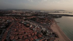 slow-motion aerial sideways video on Algeciras City in spain with landscape view of city and commercial harbor during sunrise