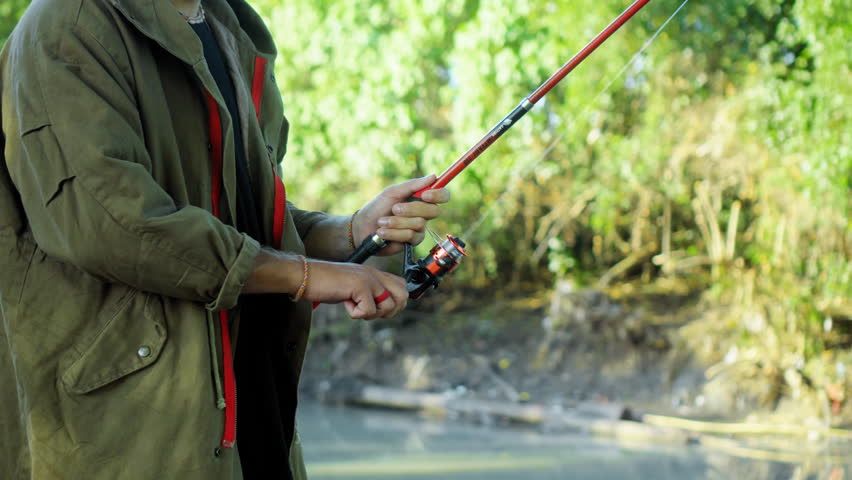 Fishing in nature with a man in a tourist robe. Men