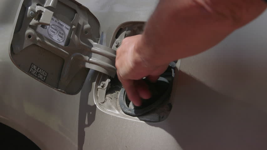 Opening the fuel cap on a motor vehicle.