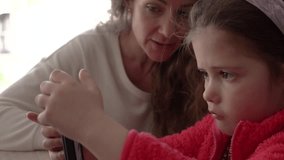 Parental Support: Mother Helping Autistic Daughter with Smartphone games. - Powered by Shutterstock - Get 15% off with code: PIKWIZARD15