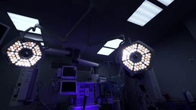 Surgical operating. 4K video with the bright lights and operation table in moody dark light. Hospital video.