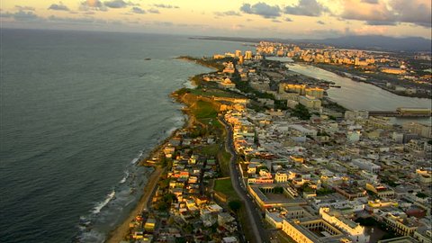 Aerial coastal sunset view of San Juan city harbor ferry terminal and cruise Port hotel and condominium resorts Puerto Rico Caribbean