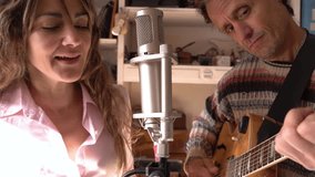 Songwriting Session: Vocalist and guitar player in Home Studio. - Powered by Shutterstock - Get 15% off with code: PIKWIZARD15