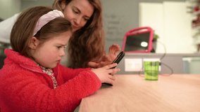 Caring Connection: Mother Assisting Autistic kid with Smartphone Messages. - Powered by Shutterstock - Get 15% off with code: PIKWIZARD15
