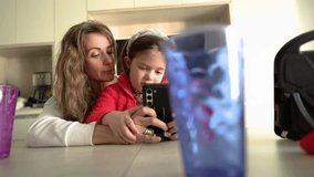 Mother Helping Autistic Daughter with Smartphone Messaging. - Powered by Shutterstock - Get 15% off with code: PIKWIZARD15
