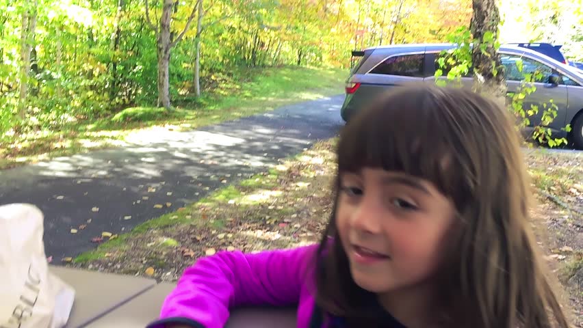 Happy young child talking in the park