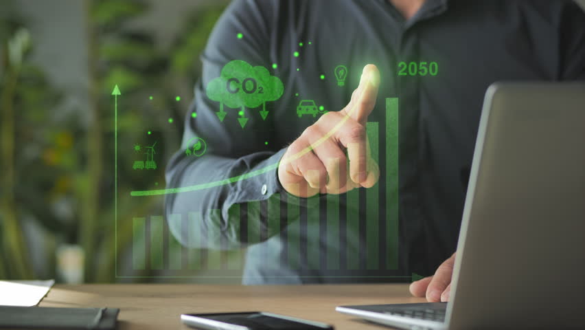 green energy zero emission carbon co2 reduction graph charts,business man at laptop computer using virtual touch screen to show alternative energy growth