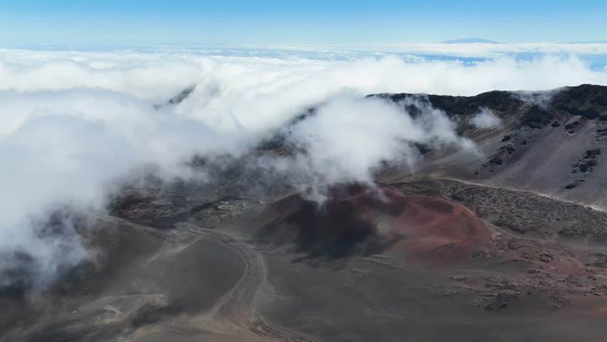 Haleakala Crater looms 10,023 feet above the Pacific Ocean, taking up three-quarters of Maui’s 727 square miles. Haleakala sunrise inspire 1.5 million visitors annually. Royalty-Free Stock Footage #3463395025