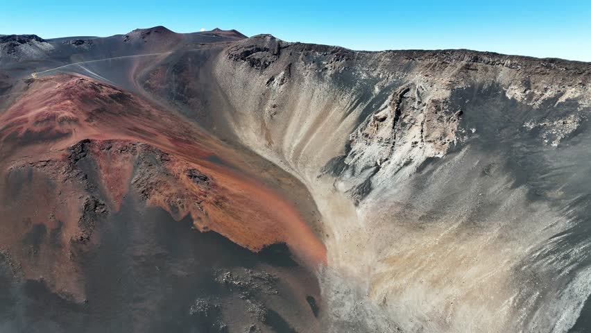 Haleakala Crater looms 10,023 feet above the Pacific Ocean, taking up three-quarters of Maui’s 727 square miles. Haleakala sunrise inspire 1.5 million visitors annually. Royalty-Free Stock Footage #3463395225